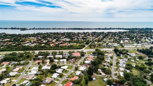 view of property location with a large body of water and nearby suburban area