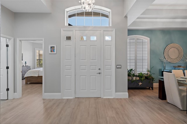 10662 Woodchase Cir, Orlando, FL 32836 - entryway featuring baseboards, a high ceiling, wood finished floors, and an inviting chandelier