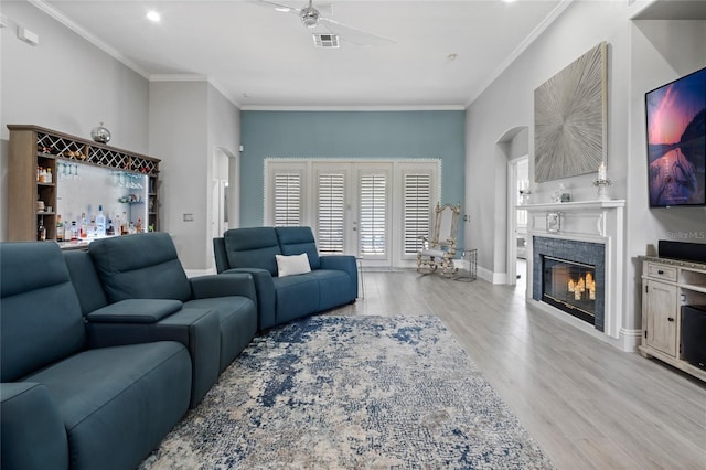 10662 Woodchase Cir, Orlando, FL 32836 - living area with visible vents, ceiling fan, ornamental molding, wood finished floors, and a glass covered fireplace