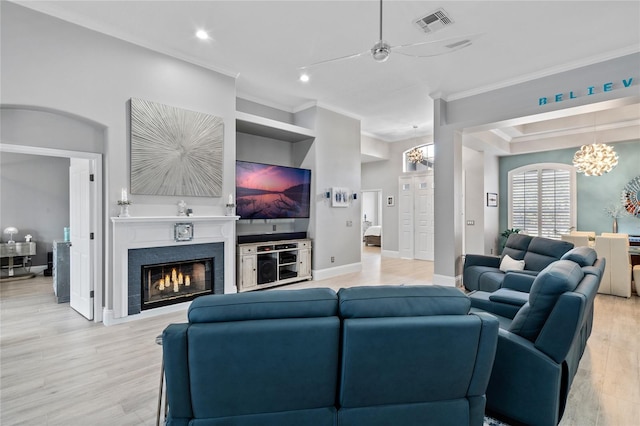 10662 Woodchase Cir, Orlando, FL 32836 - living room with visible vents, crown molding, light wood finished floors, baseboards, and ceiling fan with notable chandelier