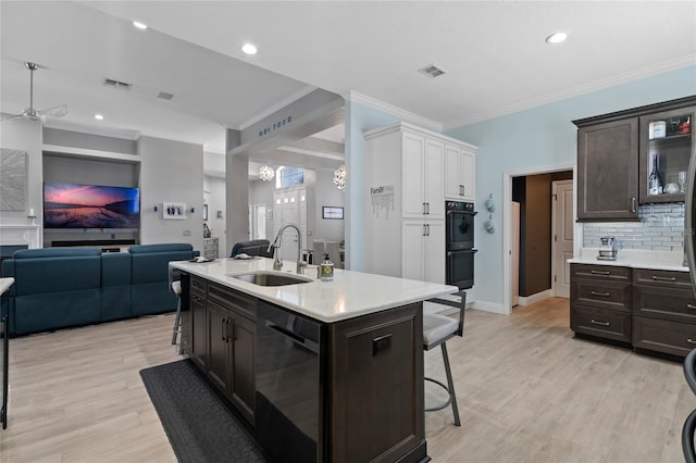 10662 Woodchase Cir, Orlando, FL 32836 - kitchen with a kitchen breakfast bar, open floor plan, a sink, visible vents, and dishwashing machine