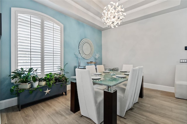 10662 Woodchase Cir, Orlando, FL 32836 - dining space featuring a tray ceiling, baseboards, wood finished floors, and a chandelier