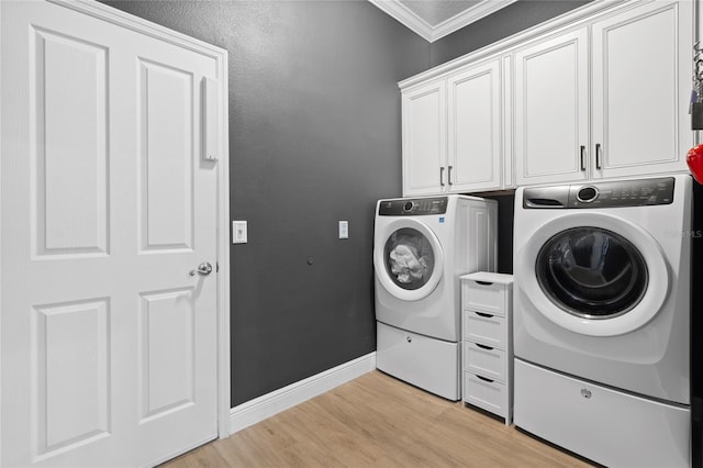 10662 Woodchase Cir, Orlando, FL 32836 - laundry area with crown molding, baseboards, light wood-style floors, cabinet space, and separate washer and dryer