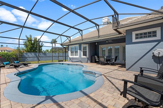 10662 Woodchase Cir, Orlando, FL 32836 - view of pool featuring glass enclosure, french doors, a fenced in pool, fence, and a patio