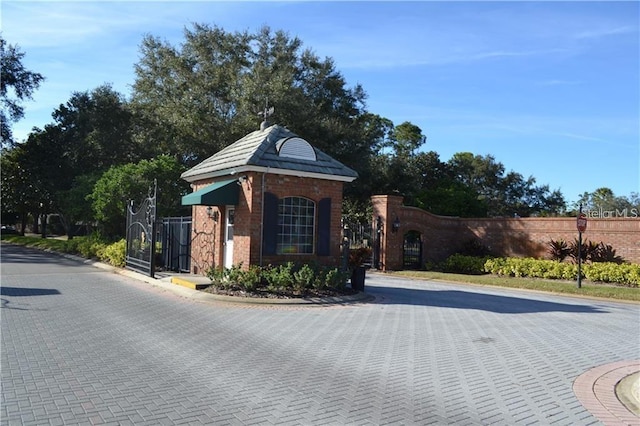10662 Woodchase Cir, Orlando, FL 32836 - view of street with a gate, a gated entry, and curbs