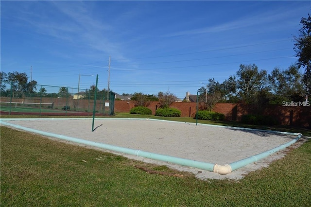 10662 Woodchase Cir, Orlando, FL 32836 - surrounding community with a yard, volleyball court, and fence