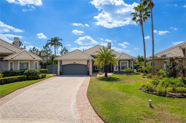 10662 Woodchase Cir, Orlando, FL 32836 - view of front of house with stucco siding, an attached garage, a tiled roof, decorative driveway, and a front yard