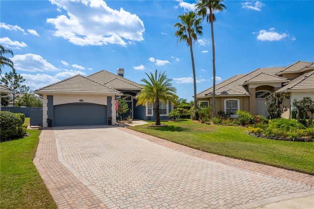 10662 Woodchase Cir, Orlando, FL 32836 - single story home with decorative driveway, a front yard, stucco siding, and a garage