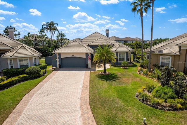 10662 Woodchase Cir, Orlando, FL 32836 - view of front facade featuring a tiled roof, a garage, decorative driveway, and stucco siding