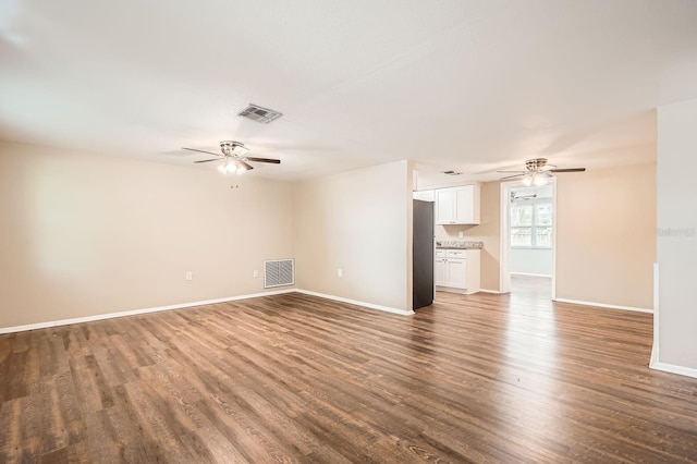 unfurnished living room featuring ceiling fan, wood finished floors, and visible vents