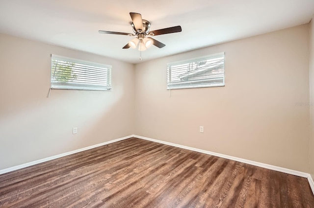 empty room with baseboards, a ceiling fan, and wood finished floors