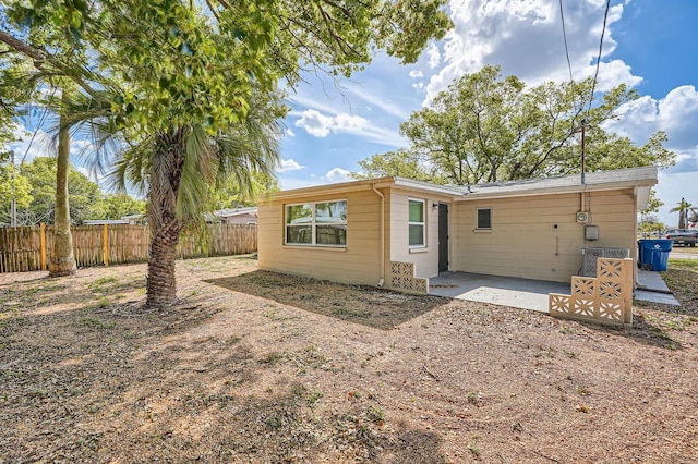 back of house with fence and a patio