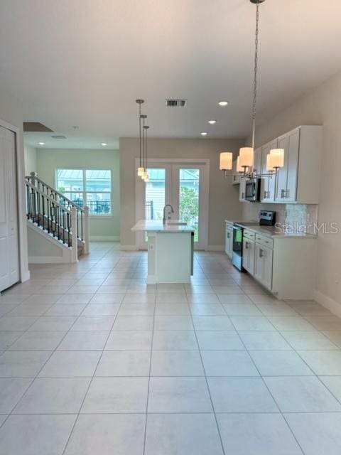 1533 Heritage Pl, Oviedo, FL 32765 - kitchen with plenty of natural light, visible vents, light countertops, and appliances with stainless steel finishes