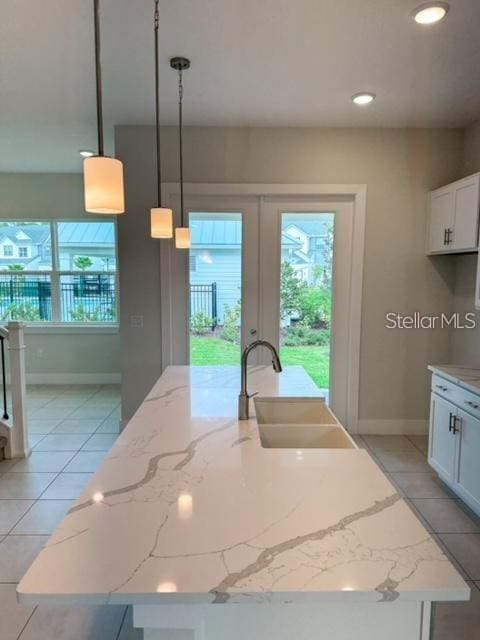 1533 Heritage Pl, Oviedo, FL 32765 - kitchen with french doors, a sink, light tile patterned flooring, and a wealth of natural light