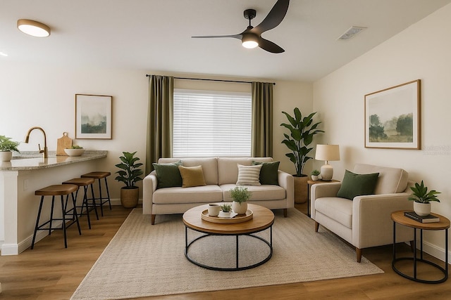 101 Dovetail Ct, Apopka, FL 32703 - living area featuring light wood-style flooring, a ceiling fan, and baseboards