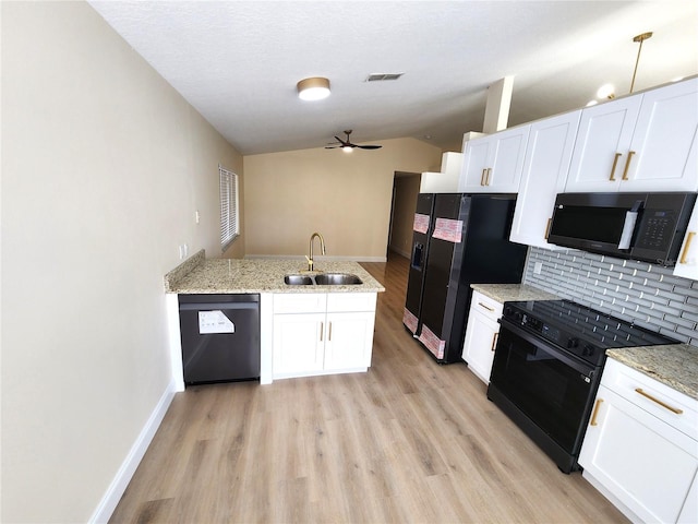 101 Dovetail Ct, Apopka, FL 32703 - kitchen with black appliances, a sink, lofted ceiling, light wood finished floors, and tasteful backsplash