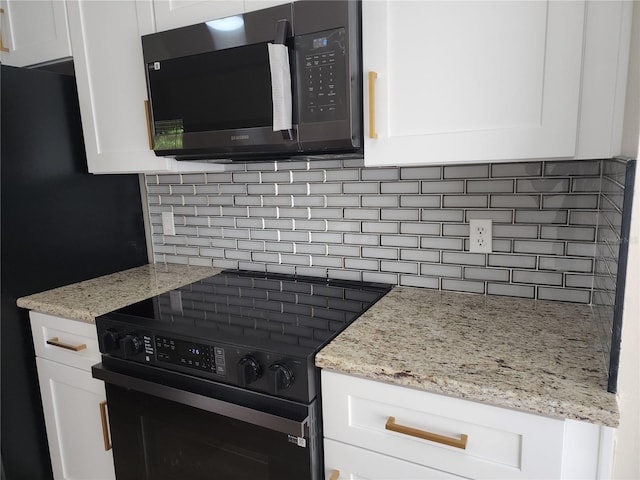 101 Dovetail Ct, Apopka, FL 32703 - kitchen featuring black appliances, decorative backsplash, white cabinetry, and light stone counters