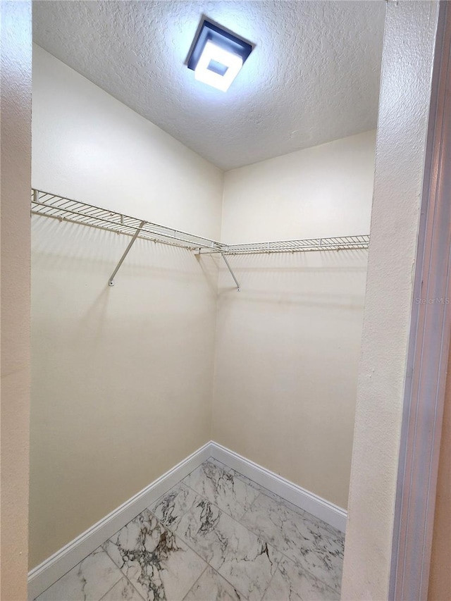 101 Dovetail Ct, Apopka, FL 32703 - walk in closet with light marble finish floors