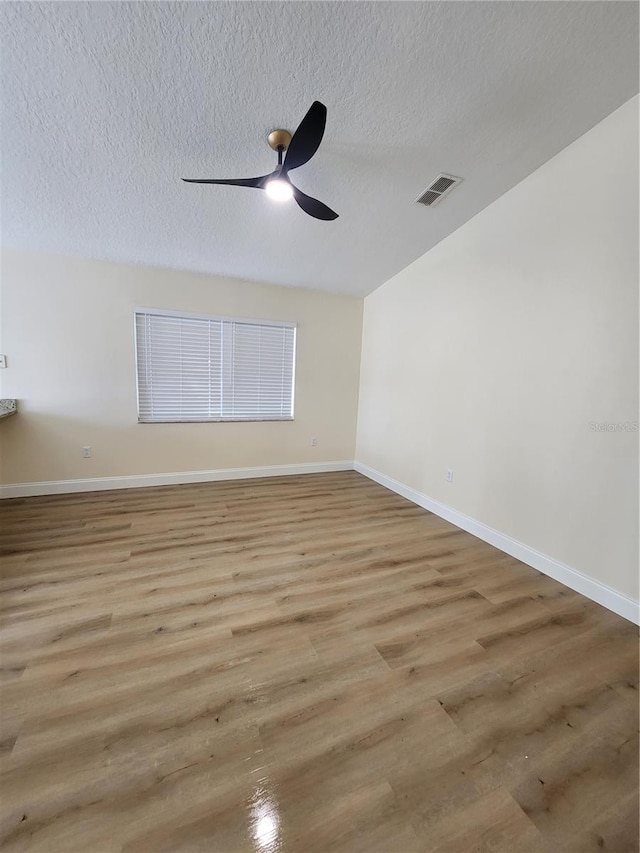101 Dovetail Ct, Apopka, FL 32703 - unfurnished room featuring wood finished floors, a textured ceiling, a ceiling fan, and baseboards