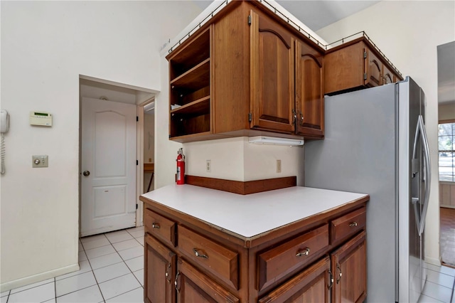 kitchen with brown cabinetry and stainless steel fridge