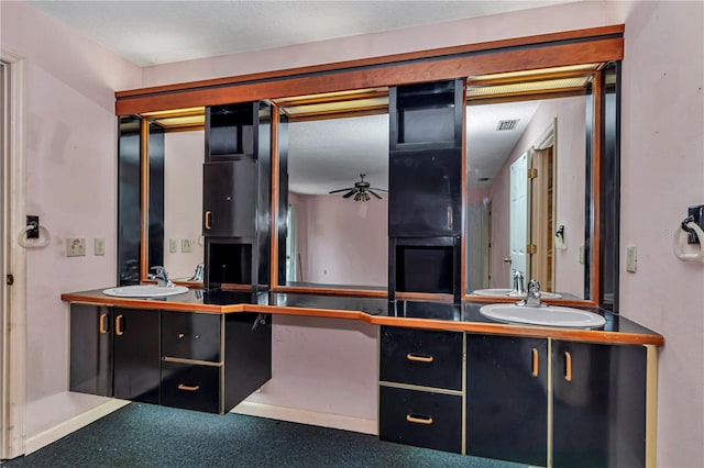 bathroom with a ceiling fan, vanity, and visible vents