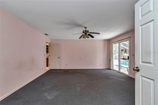 unfurnished room with baseboards, visible vents, dark colored carpet, and ceiling fan
