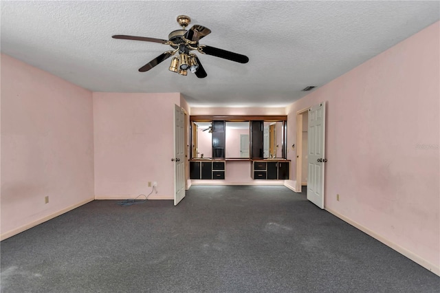 unfurnished living room with a textured ceiling, baseboards, ceiling fan, and visible vents