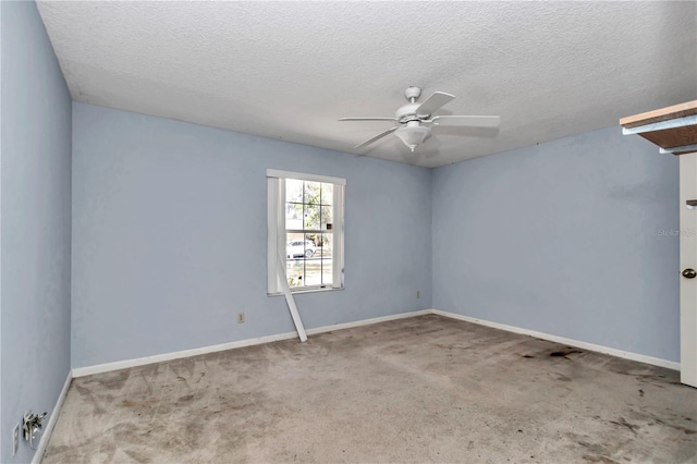 spare room with carpet flooring, a ceiling fan, baseboards, and a textured ceiling