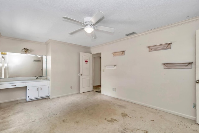 unfurnished bedroom featuring crown molding, a sink, a textured ceiling, baseboards, and visible vents