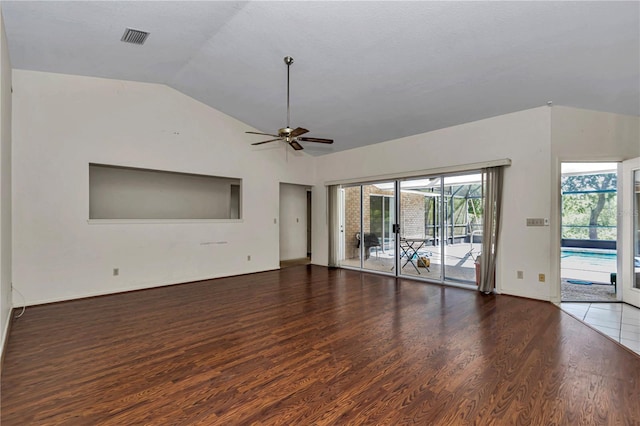 unfurnished living room with lofted ceiling, baseboards, visible vents, a ceiling fan, and wood finished floors