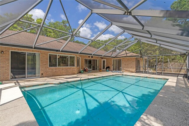 view of pool featuring fence, a lanai, a patio, and a fenced in pool