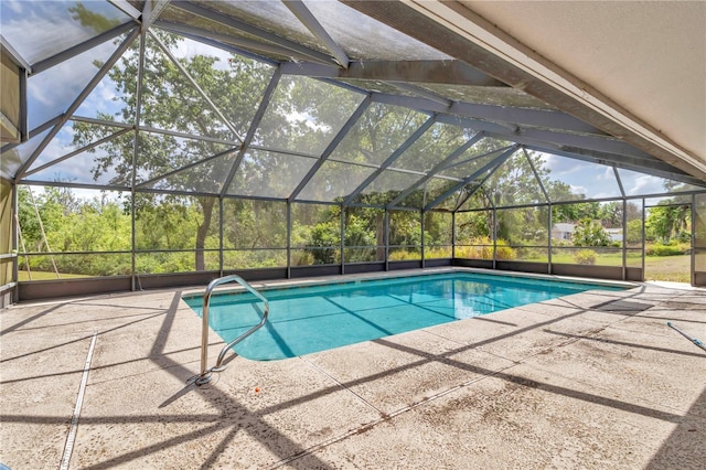 pool with a lanai and a patio area