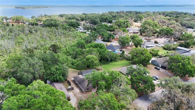 birds eye view of property with a forest view and a water view