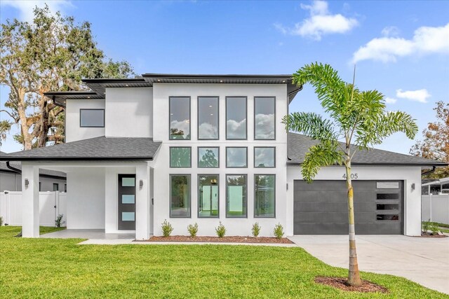 4405 Rockledge Rd, Orlando, FL 32807 - view of front of home featuring stucco siding, fence, an attached garage, driveway, and a front yard