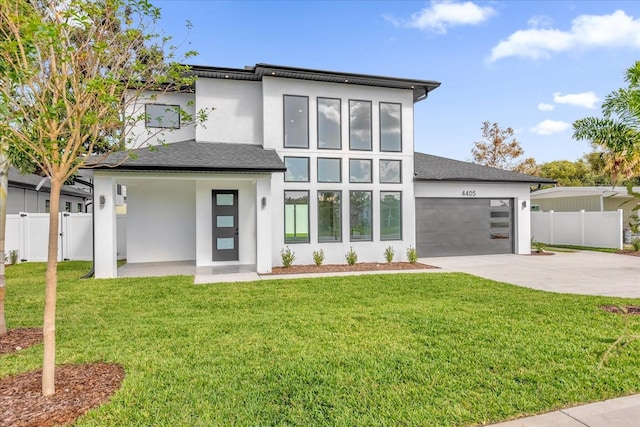 4405 Rockledge Rd, Orlando, FL 32807 - modern home featuring fence, stucco siding, a garage, and concrete driveway