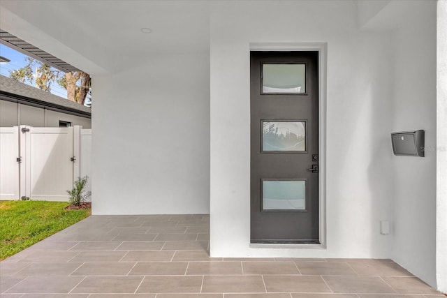 4405 Rockledge Rd, Orlando, FL 32807 - view of exterior entry featuring a gate, stucco siding, and a patio