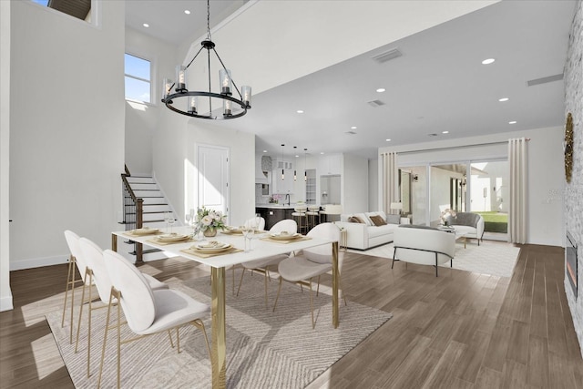 4405 Rockledge Rd, Orlando, FL 32807 - dining room featuring stairway, wood finished floors, visible vents, recessed lighting, and an inviting chandelier