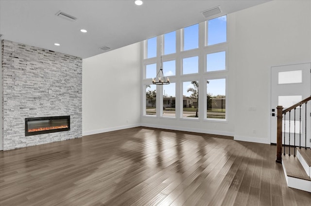 4405 Rockledge Rd, Orlando, FL 32807 - unfurnished living room with visible vents, wood finished floors, stairway, and a fireplace