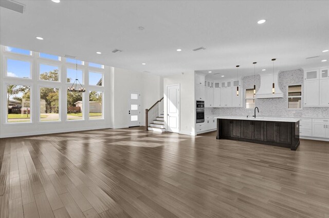 4405 Rockledge Rd, Orlando, FL 32807 - unfurnished living room featuring a sink, dark wood-style floors, stairs, and recessed lighting