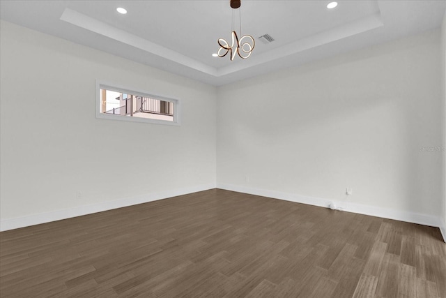 4405 Rockledge Rd, Orlando, FL 32807 - empty room featuring a raised ceiling, baseboards, and dark wood finished floors