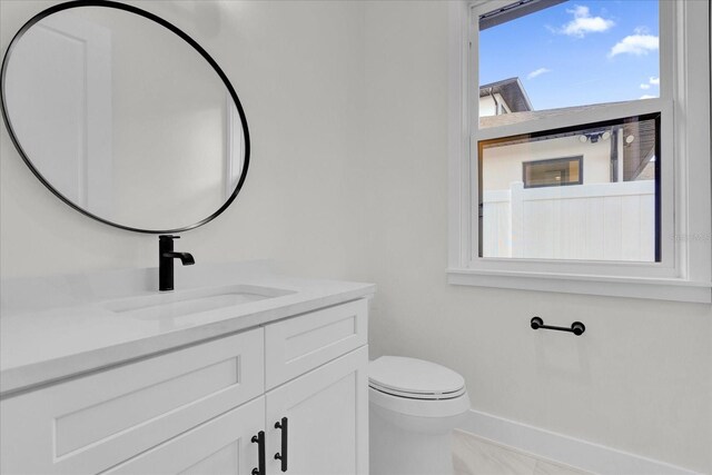 4405 Rockledge Rd, Orlando, FL 32807 - half bath featuring toilet, vanity, and baseboards