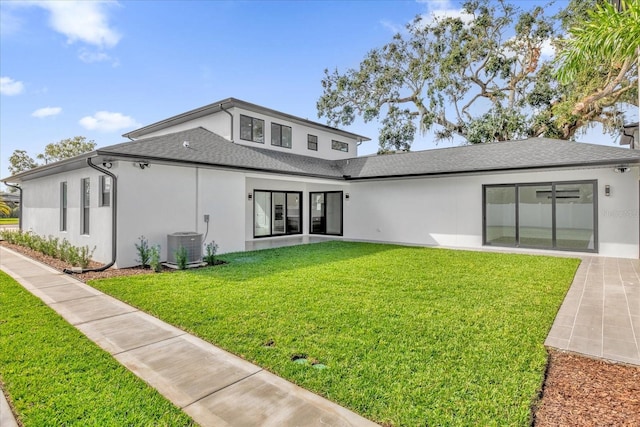 4405 Rockledge Rd, Orlando, FL 32807 - rear view of house with cooling unit, stucco siding, roof with shingles, and a lawn