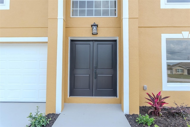 entrance to property featuring stucco siding