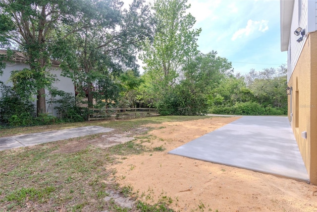 view of yard with fence and a patio