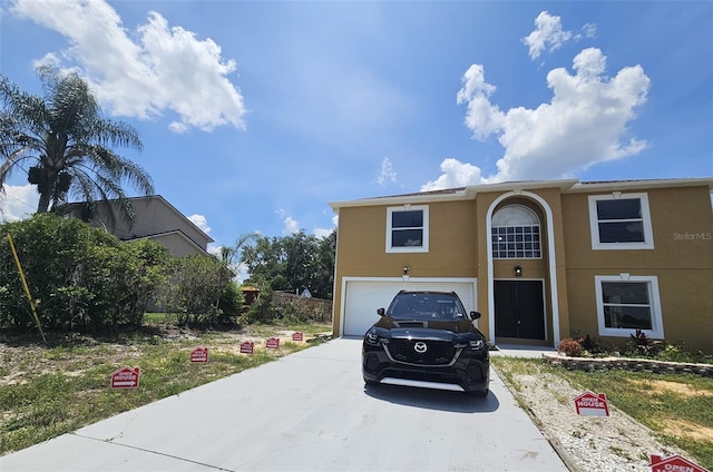 2004 Prescott Blvd, Deltona, FL 32738 - view of front facade featuring concrete driveway, an attached garage, and stucco siding