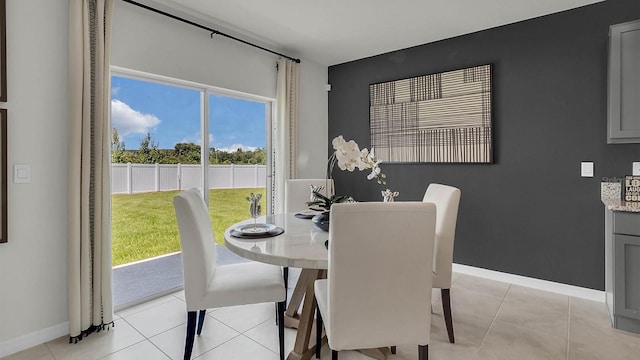 dining area featuring baseboards and light tile patterned floors
