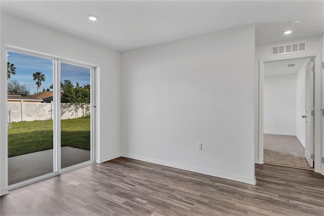 1032 Cannock Dr, Kissimmee, FL 34758 - spare room featuring baseboards, visible vents, wood finished floors, and recessed lighting