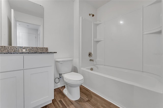 1032 Cannock Dr, Kissimmee, FL 34758 - full bath with bathtub / shower combination, toilet, vanity, wood finished floors, and baseboards