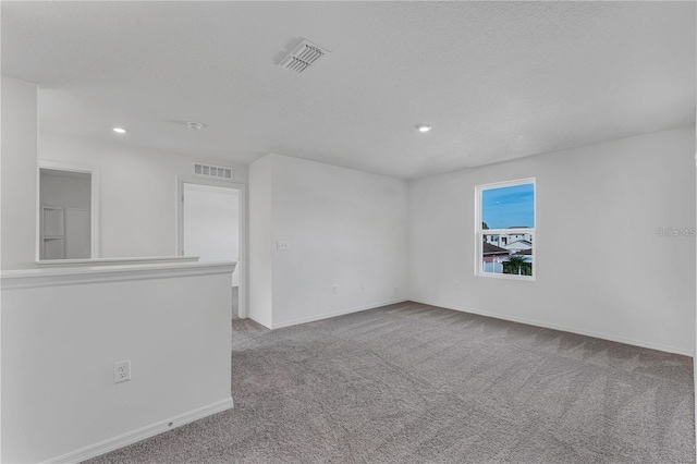 1032 Cannock Dr, Kissimmee, FL 34758 - carpeted spare room with baseboards, visible vents, recessed lighting, and a textured ceiling