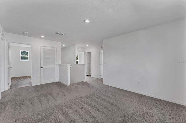 1032 Cannock Dr, Kissimmee, FL 34758 - carpeted empty room with recessed lighting, a textured ceiling, baseboards, and visible vents